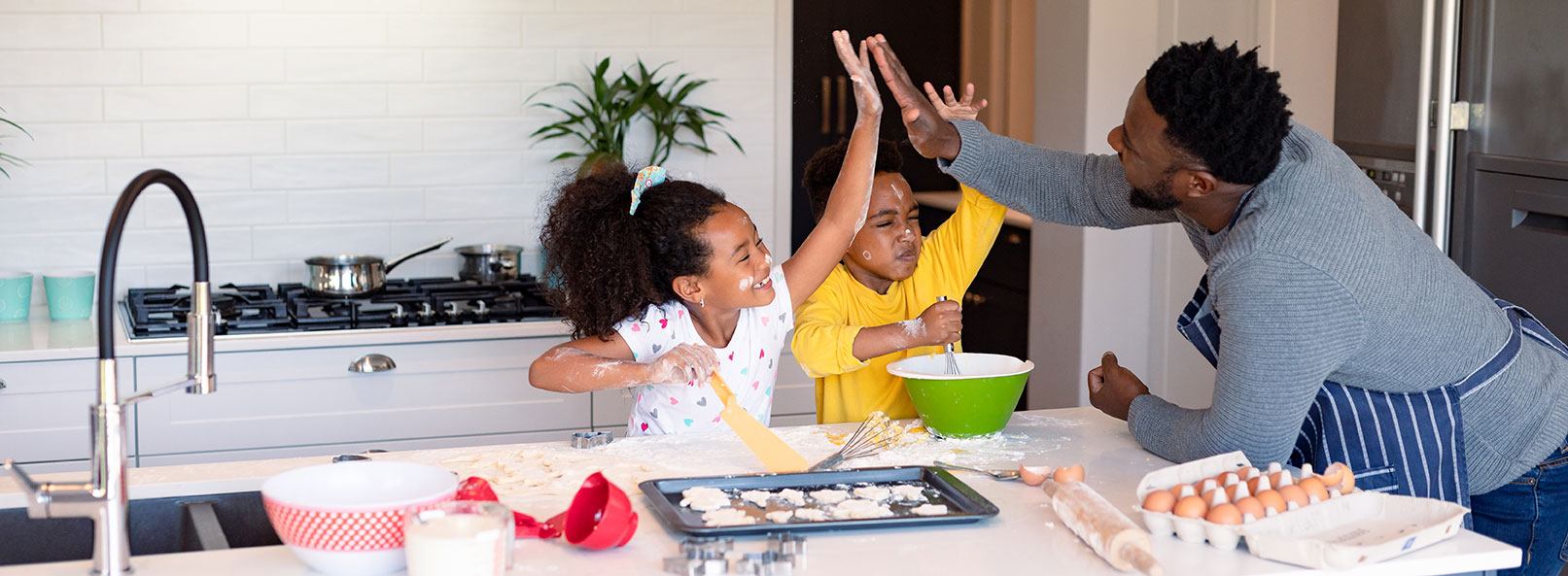 happy-african-american-father-and-siblings-baking-2023-11-27-05-26-08-utc